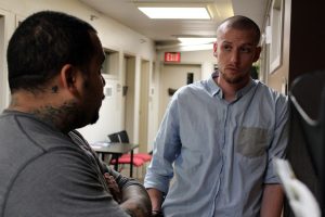 Fellow veteran Jordan Sherwood (right) talks with Mesa Community College student Devon Caballero-Zarate (left) about switching into a more suitable class.