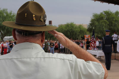 A veteran salutes during the posting of the colors National Memorial Cemetery of Arizona. (Photo by Chad Garland, News21)